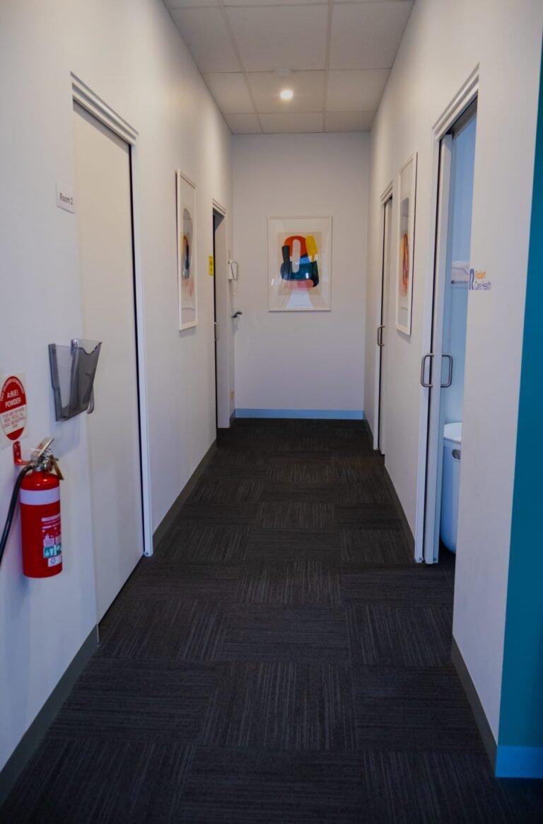 Hallway at Reservoir clinic with signed Room 2 and Radiant Care Health treatment rooms
