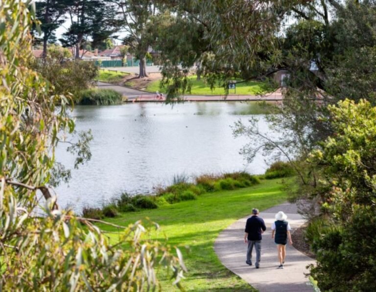 People walking on a tree-lined park path near our Reservoir physiotherapy clinic