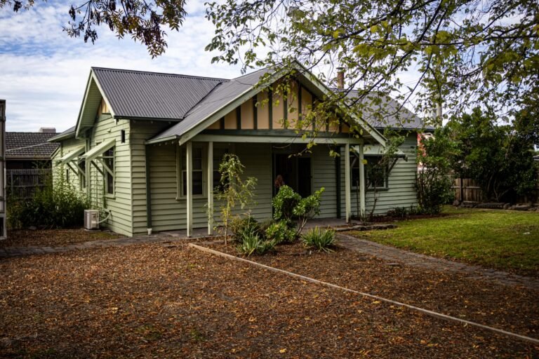 Side view of green weatherboard Radiant Care Health Mernda clinic with porch