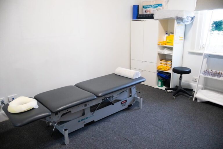 Mernda clinic treatment room with adjustable table, stool, equipment storage and cupping cups