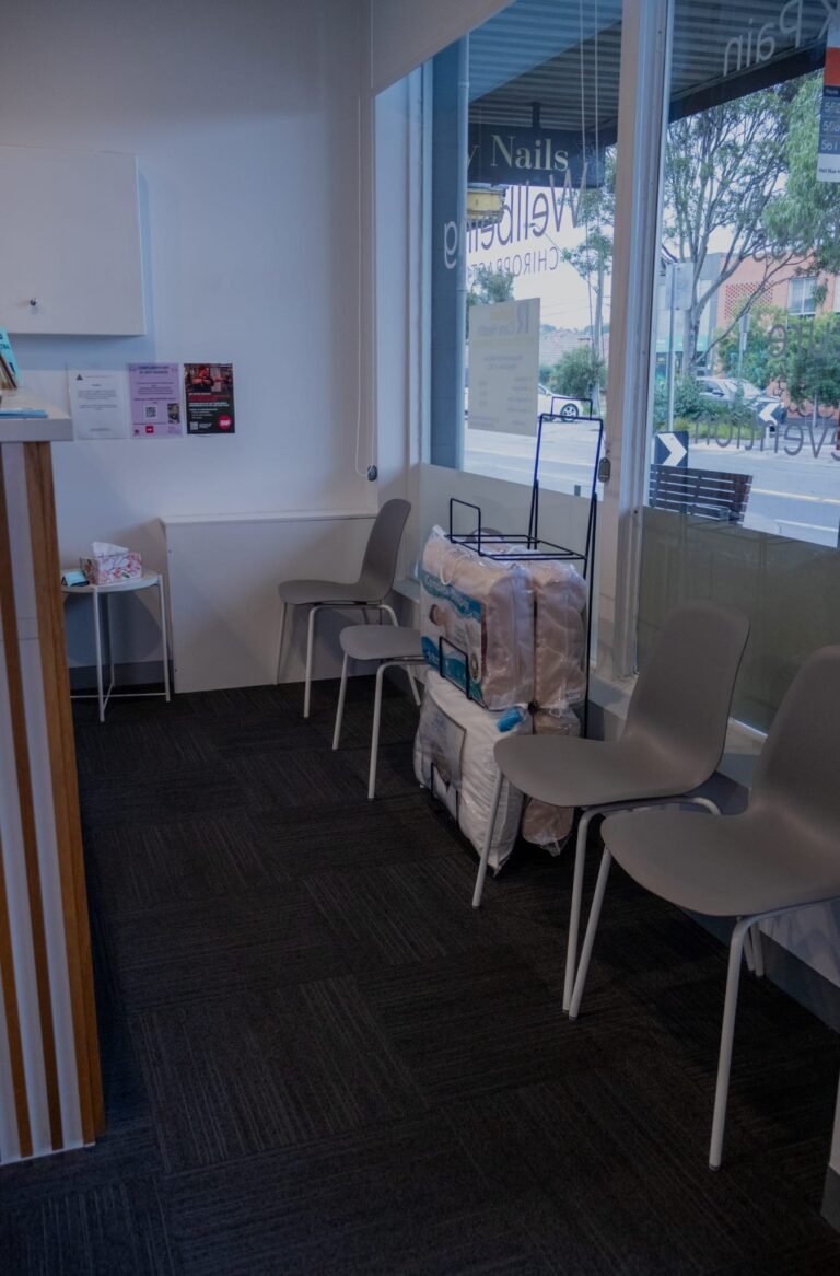 Reservoir clinic waiting area with grey chairs and shopfront window view of Broadway, Reservoir