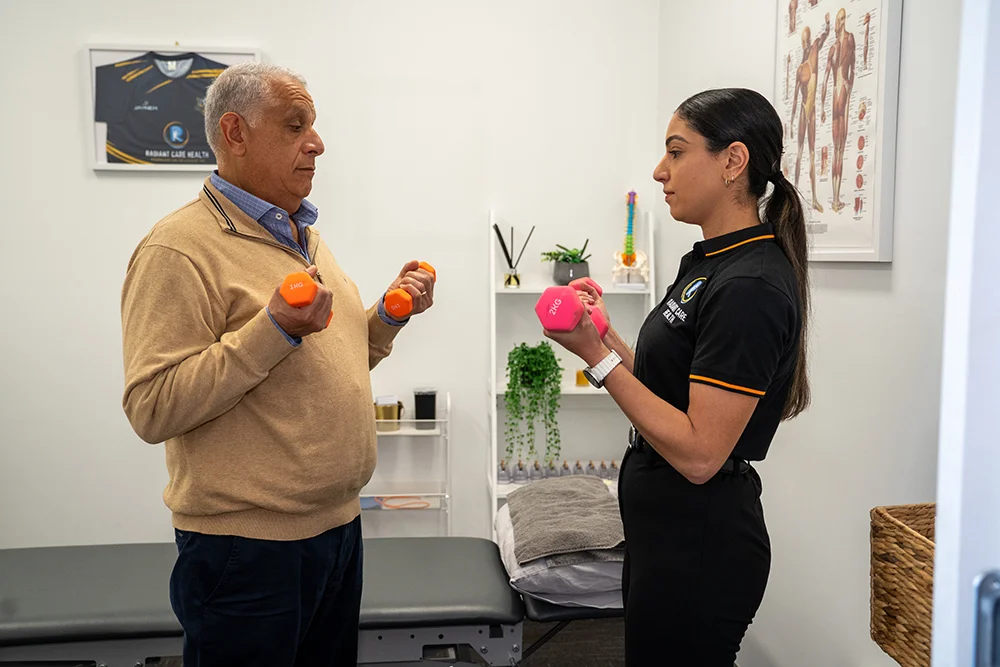 Neck Pain After a Car Accident? Whiplash & TAC Guide 3 Physiotherapist guiding gentle neck movement to treat whiplash at Radiant Care Health.
