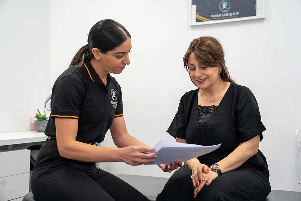 Neck Pain After a Car Accident? Whiplash & TAC Guide 4 Physiotherapist explaining the TAC recovery process to a patient.