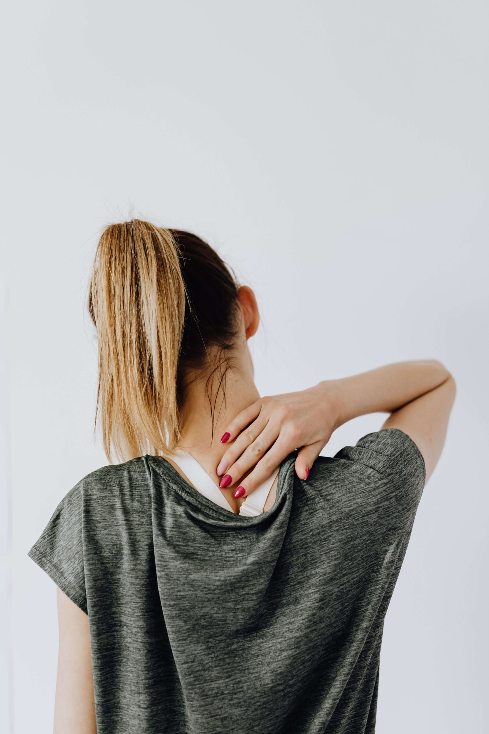 Neck Pain After a Car Accident? Whiplash & TAC Guide 1 Person holding their neck with whiplash pain after a car accident.